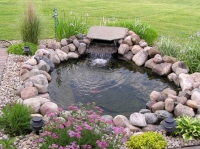 Pond with circulating two-tiered waterfall